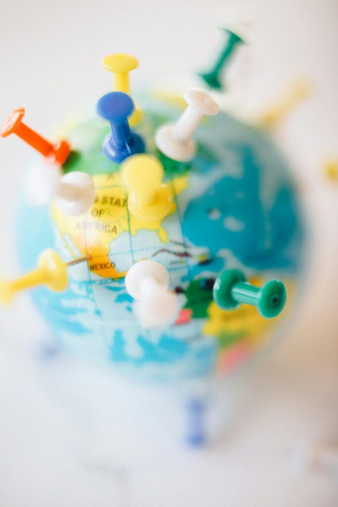 A vibrant globe with colorful pins marking destinations, symbolizing travel plans.