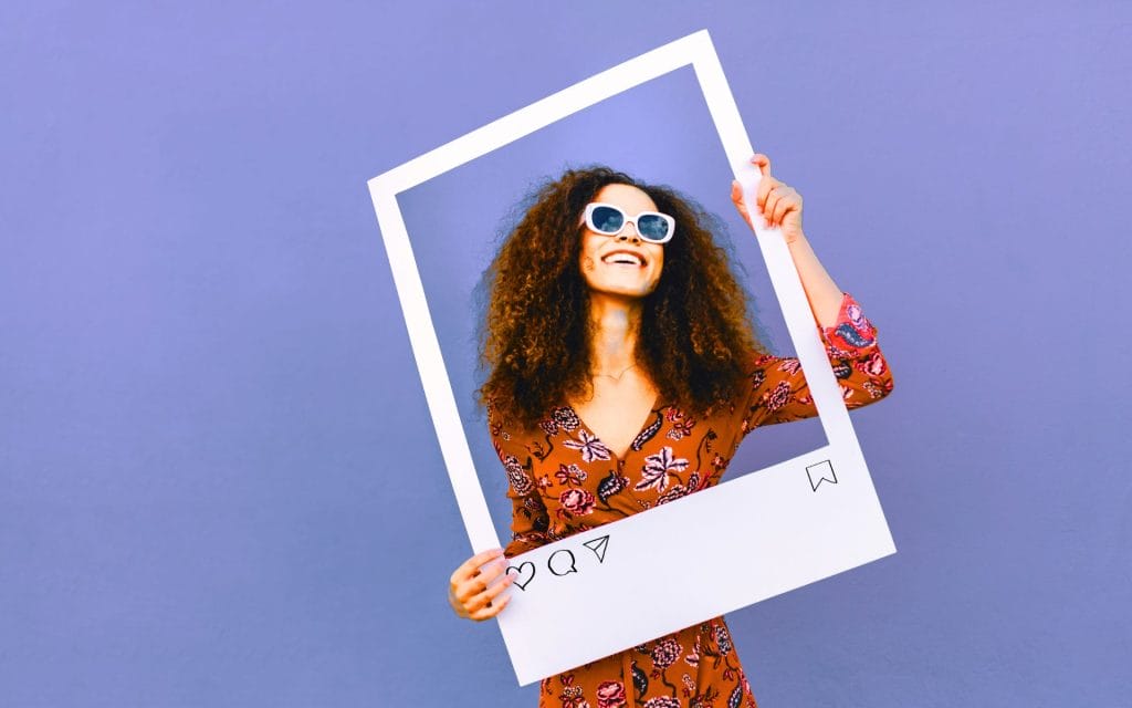 Person holding large photo frame. social media marketing